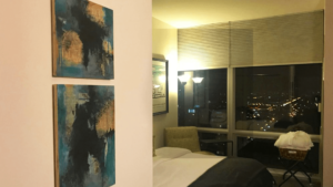 two-paintings-hanging-on-bedroom-wall