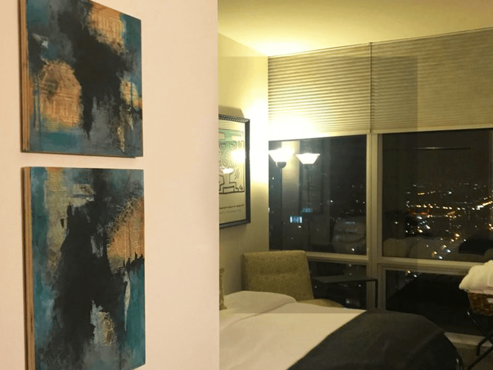 two-paintings-hanging-on-bedroom-wall